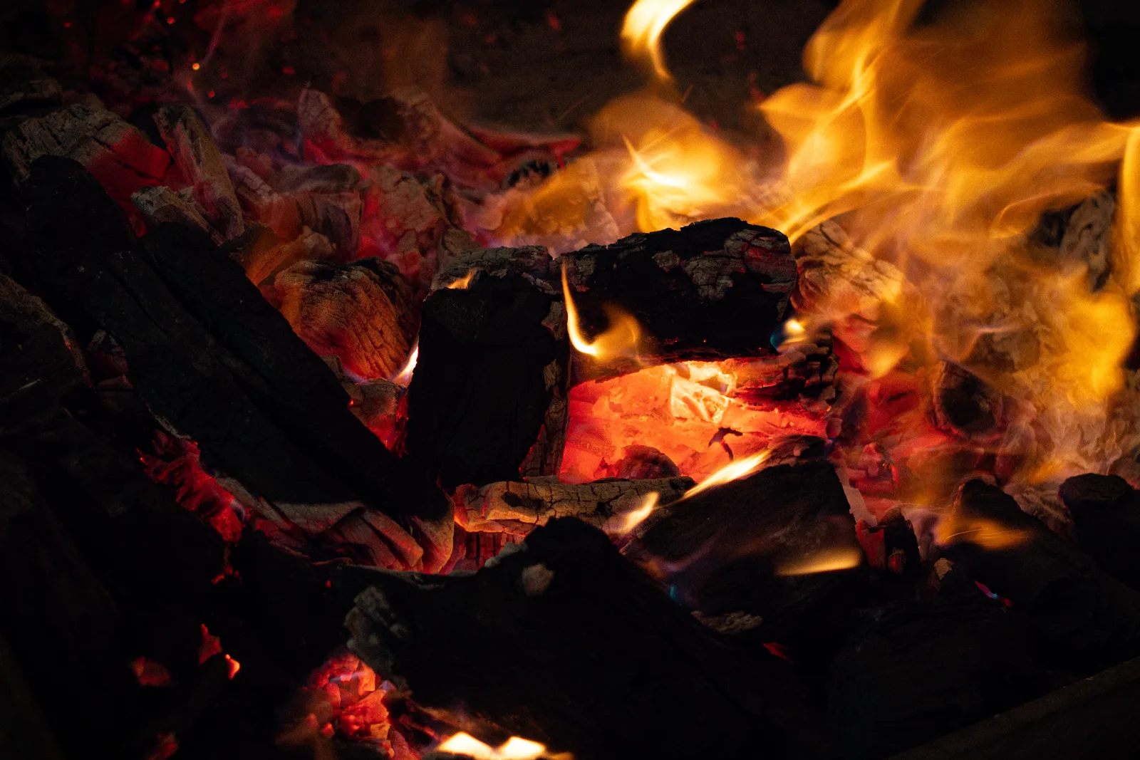 Glowing mesquite coals and flame in the grill